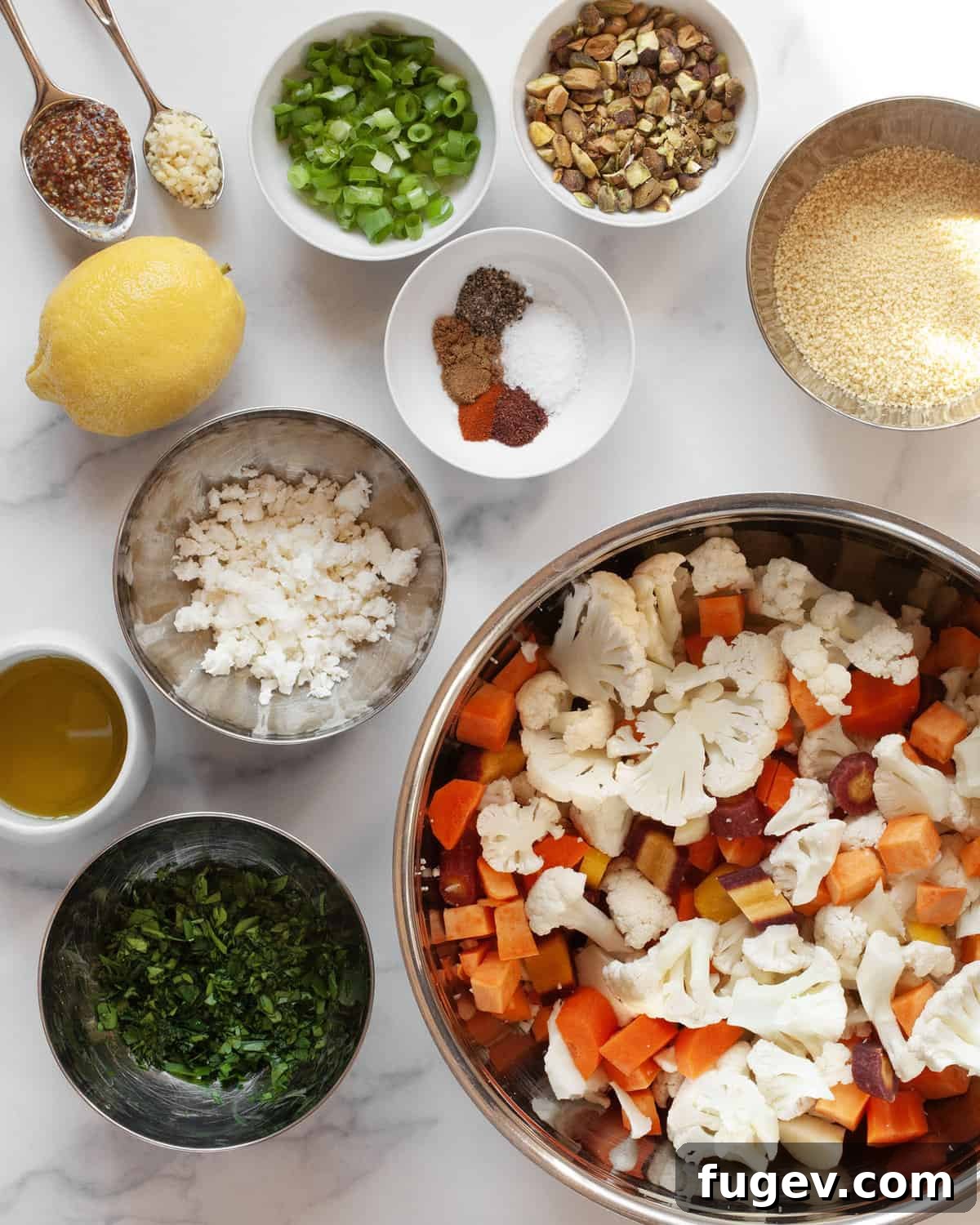 Warm Roasted Harvest Salad 3 A selection of fresh ingredients including sweet potatoes, cauliflower, carrots, feta, scallions, parsley, pistachios, spices, couscous, lemon, and olive oil.