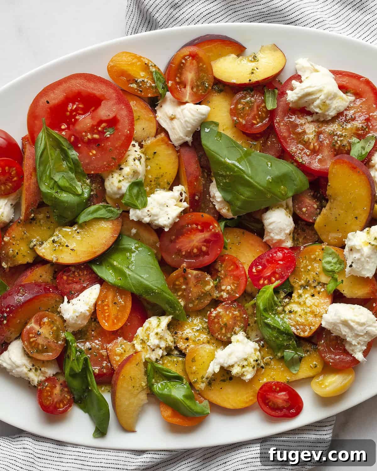 Summer Peach Caprese Salad 6 Detail image of peach caprese salad. A generous portion arranged on a plate, highlighting the fresh ingredients and vibrant colors.