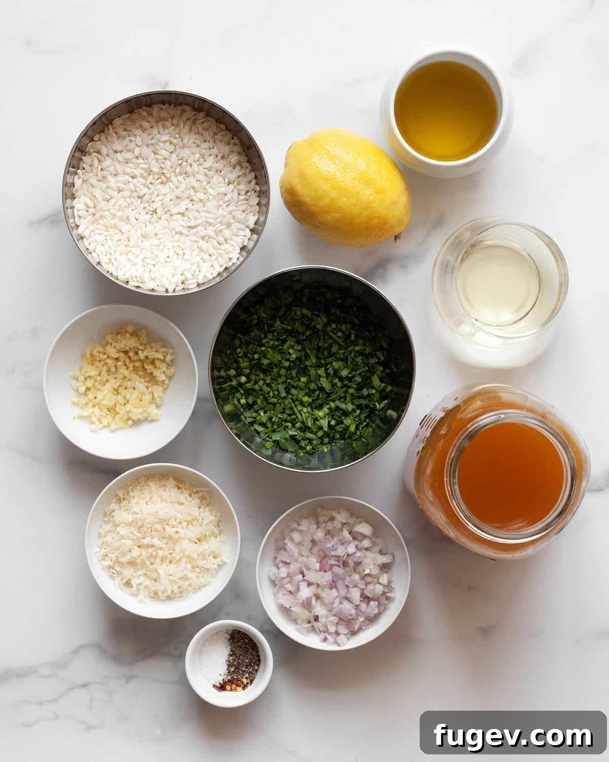 Golden Baked Lemon Risotto 3 Ingredients for baked lemon risotto including arborio rice, a fresh lemon, grated parmesan, chopped shallots, minced garlic, fresh parsley and chives, vegetable broth, salt, pepper, and olive oil.