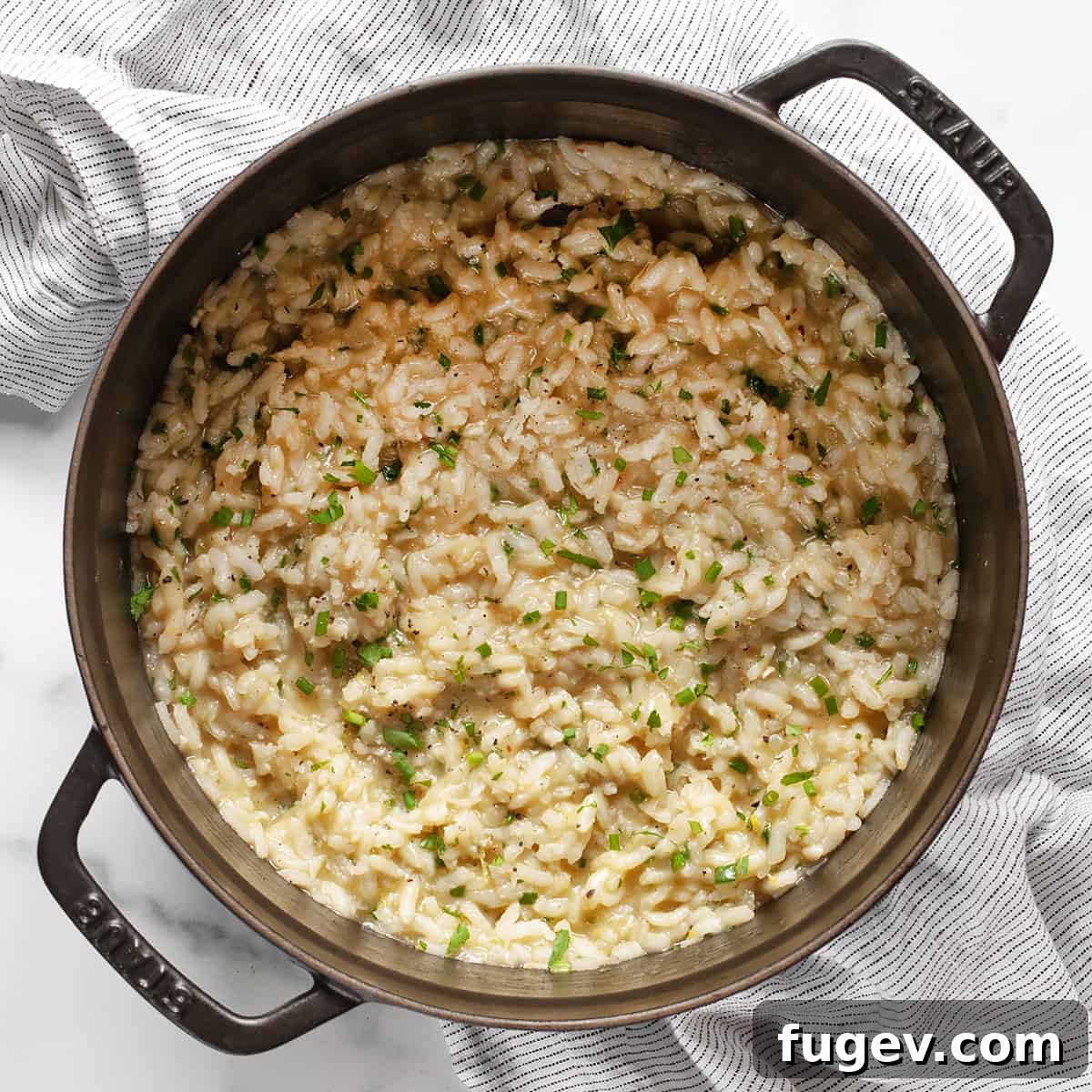 Golden Baked Lemon Risotto 7 Baked lemon risotto in a Dutch oven, showing its creamy texture.