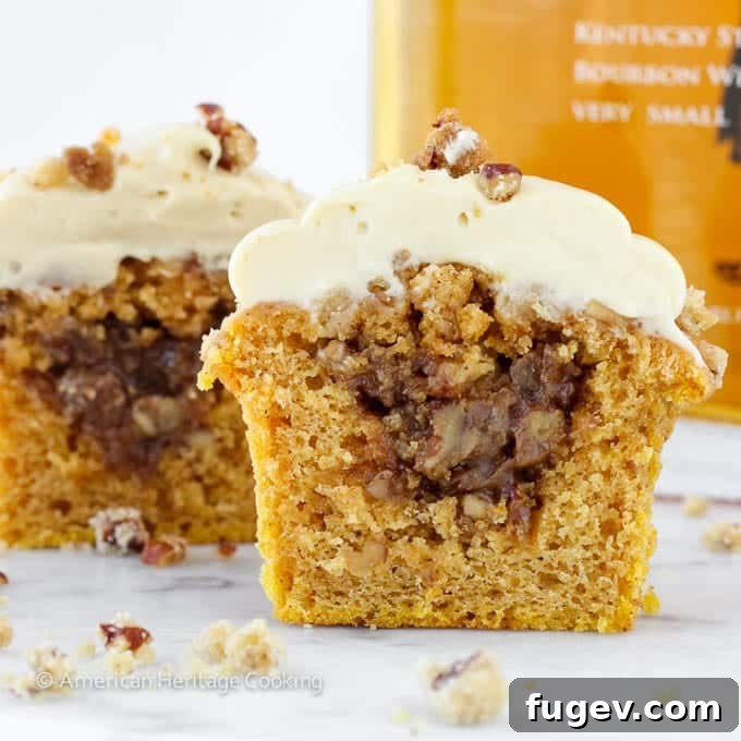 Toasted Pecan Pumpkin Pie Cupcakes 3 Close-up of a Pumpkin Pecan Pie Cupcake showing the fluffy cake and creamy frosting.