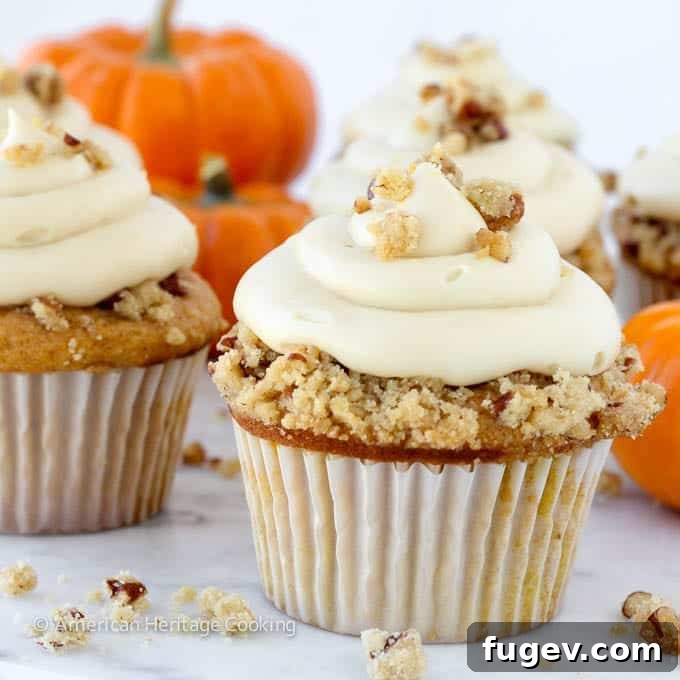 Toasted Pecan Pumpkin Pie Cupcakes 4 Pumpkin Pecan Pie Cupcake with a bite taken out, revealing the pecan pie filling.