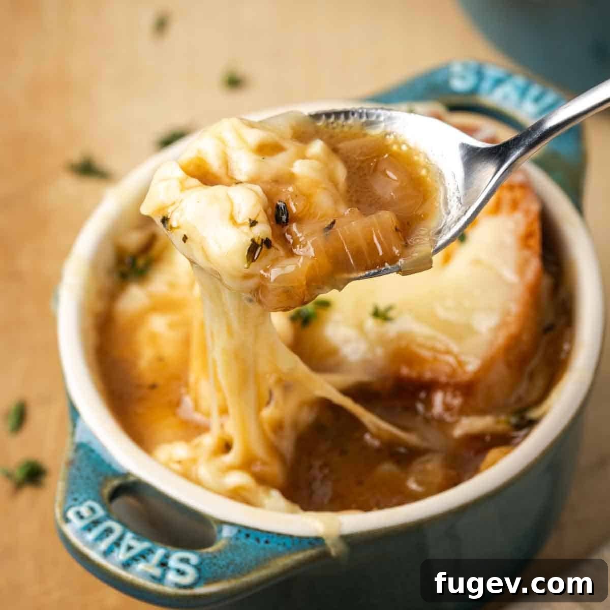 The Quintessential French Onion 11 perfect bite of french onion soup on spoon.