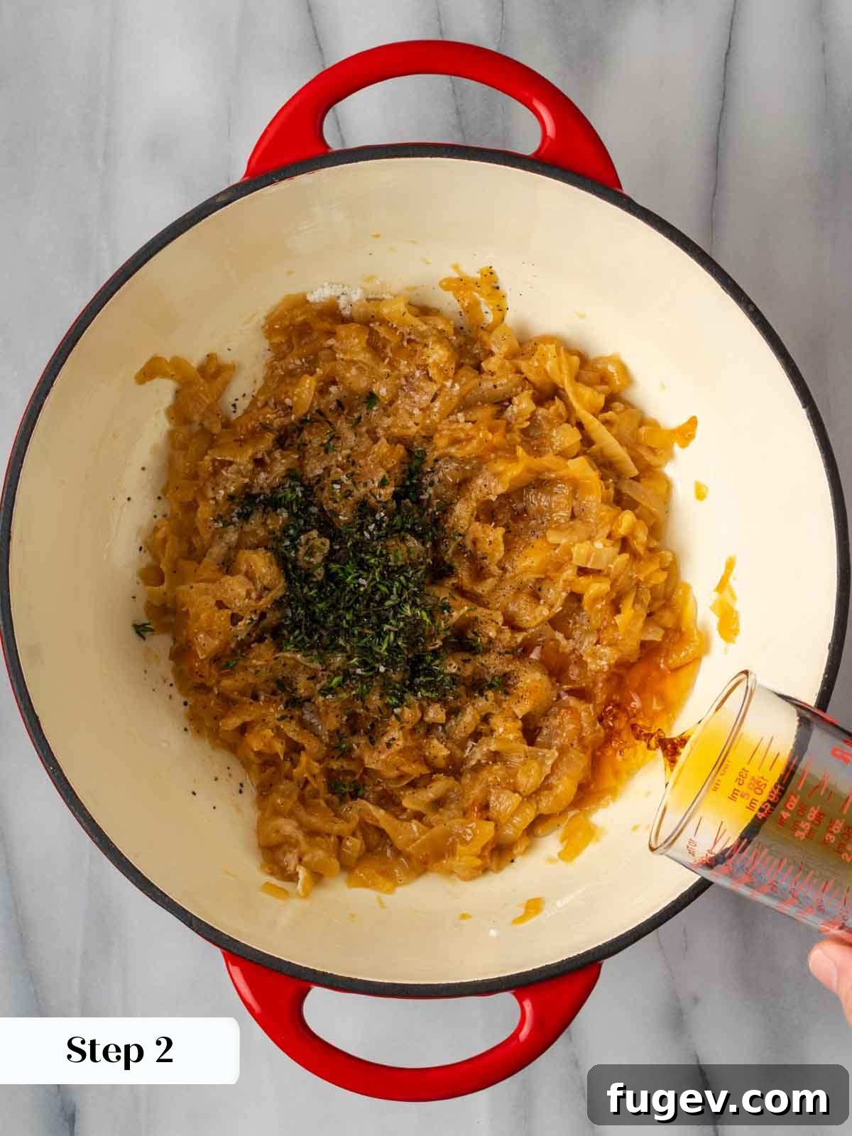 The Quintessential French Onion 6 adding thyme and cognac to caramelized onions in pot.