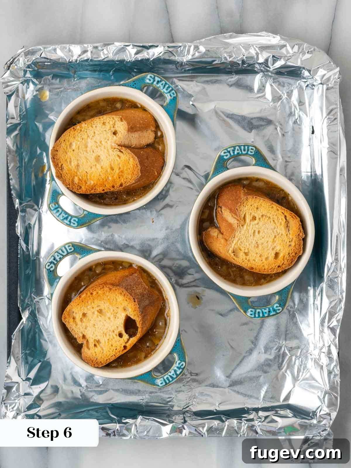 The Quintessential French Onion 9 toasted bread on top of soup before cheese.