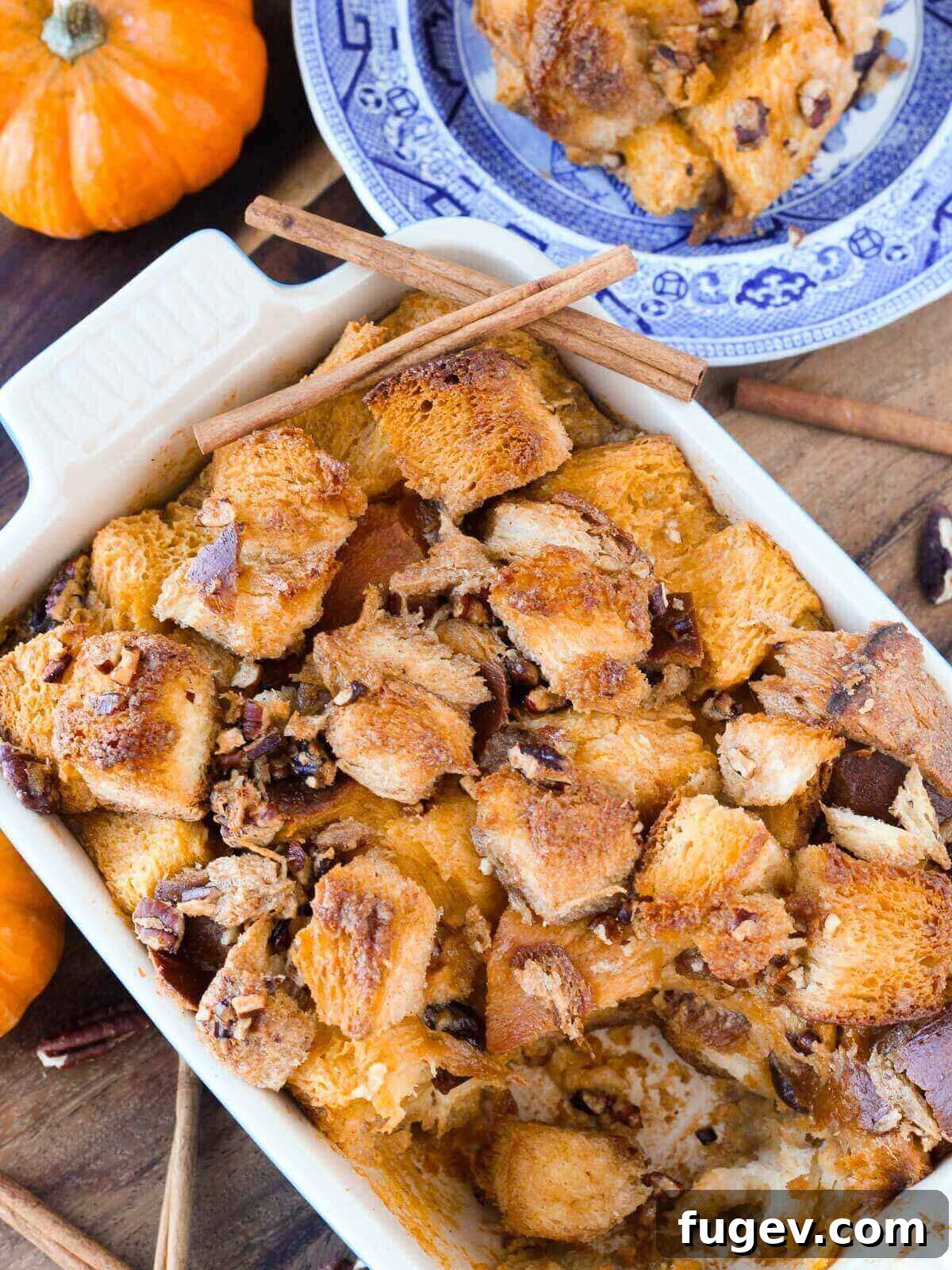 Cozy Pumpkin Bread Pudding 3 Pumpkin bread pudding in a blue baking dish, ready for serving.