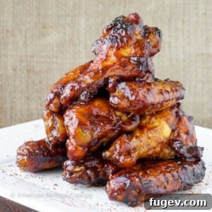 A pile of baked chicken wings glistening in a perfectly thick sauce, ready to be served.