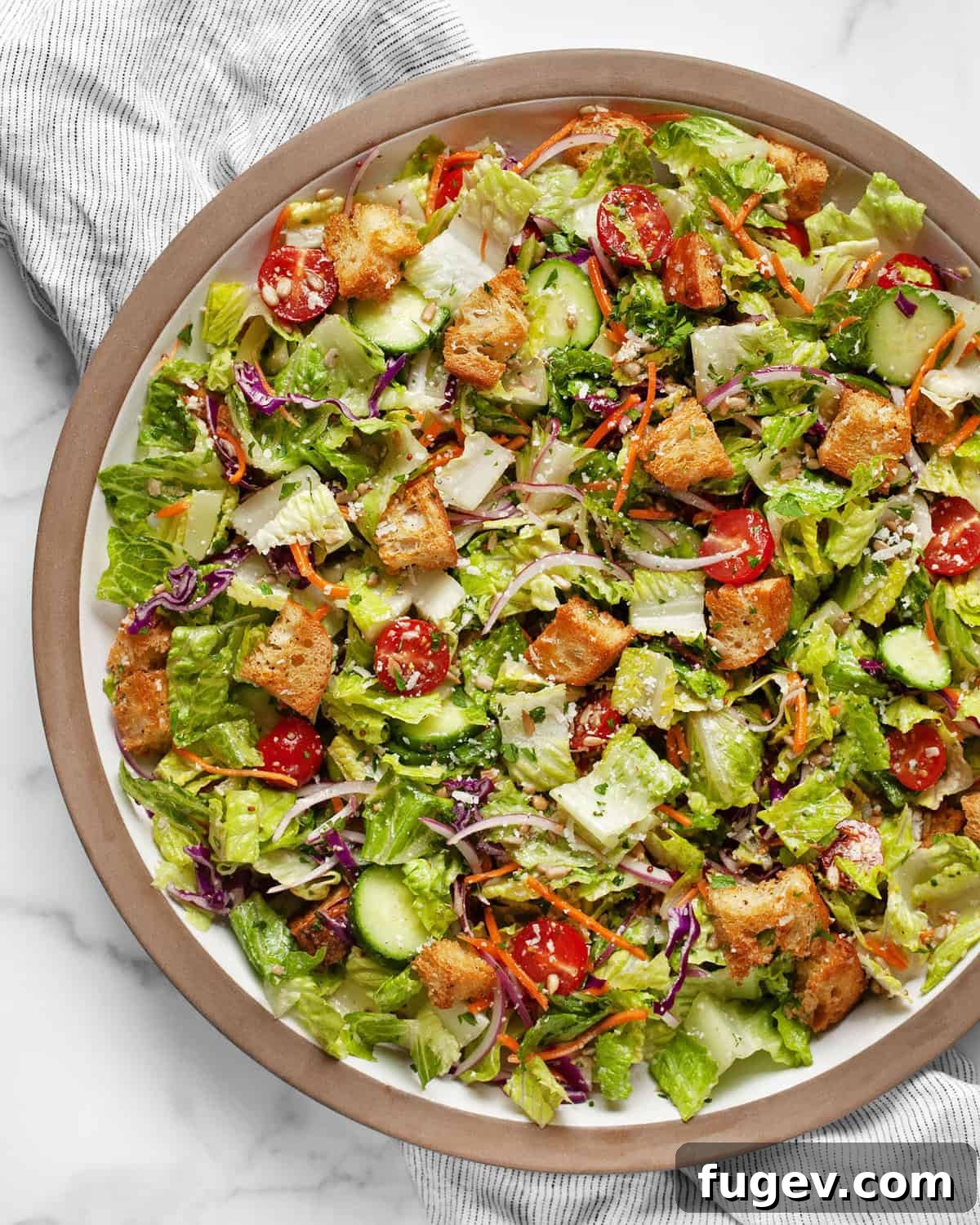 Garden Fresh Salad 2 A vibrant and fresh house salad generously arranged on a large serving dish, ready to be enjoyed.