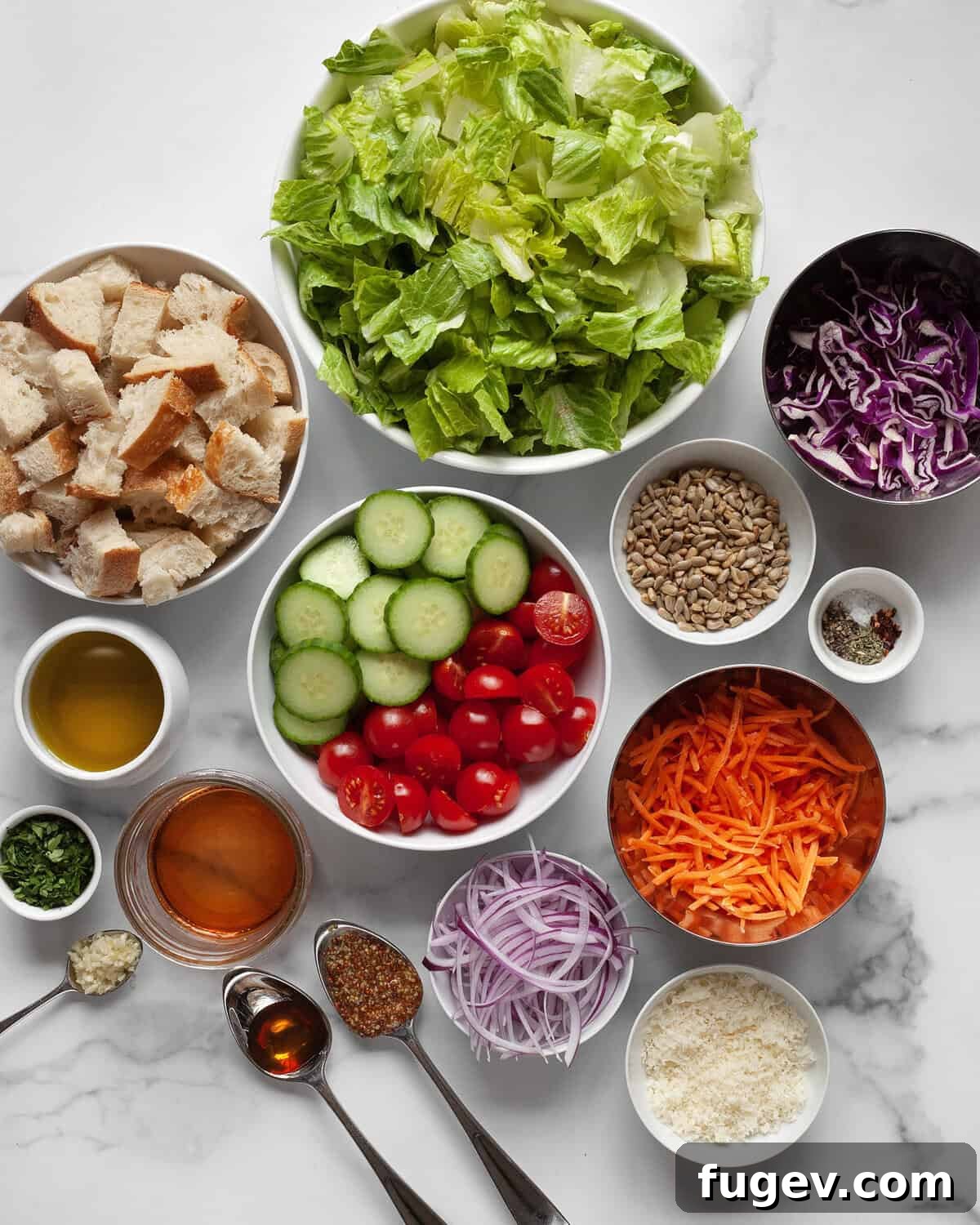 Garden Fresh Salad 3 A beautiful flat lay of fresh house salad ingredients including crisp romaine, colorful tomatoes, cucumbers, shredded cabbage and carrots, alongside parmesan cheese, olive oil, vinegar, and torn bread for croutons.