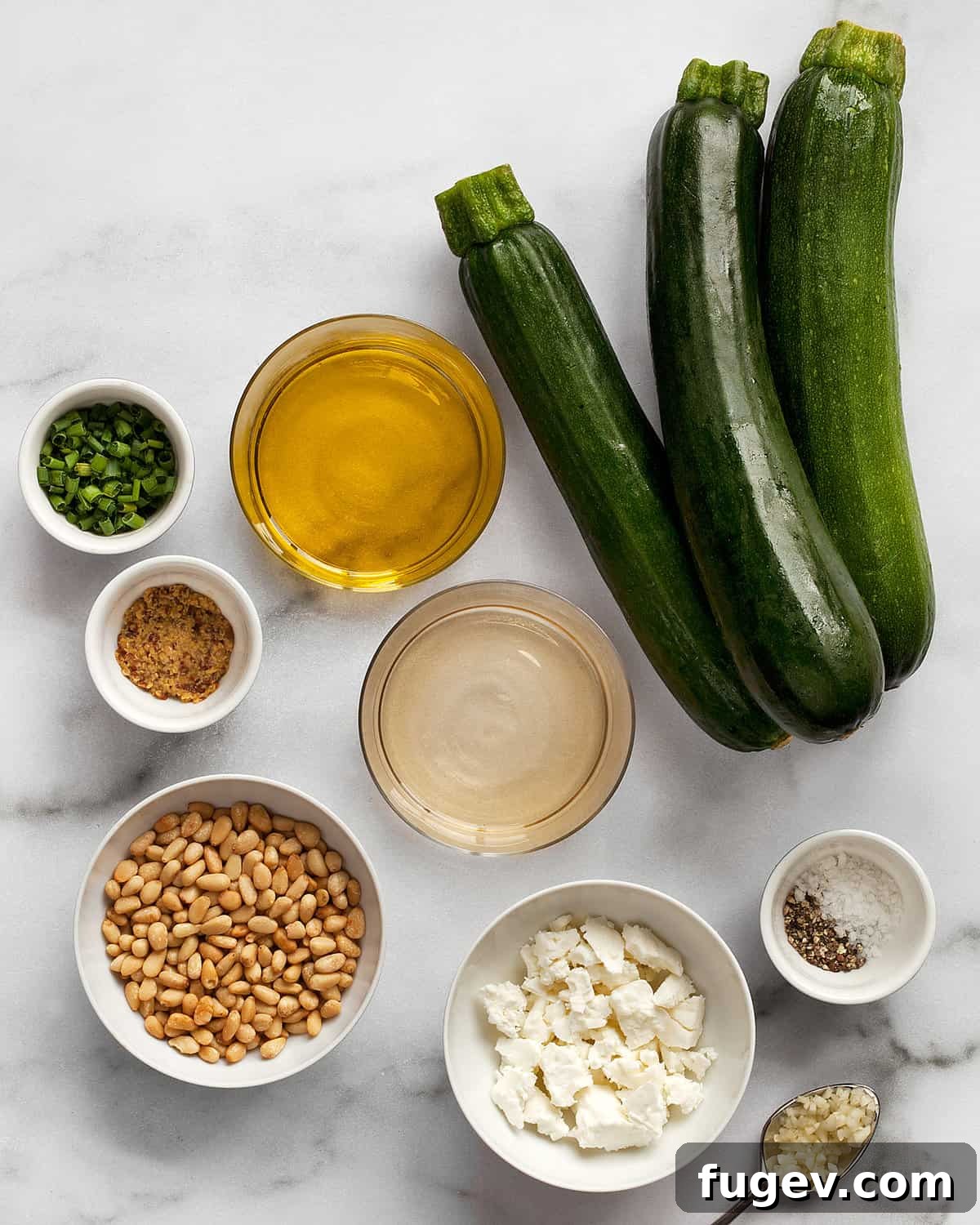 Zesty Zucchini Salad with Feta and Pine Nuts 3 Close-up of fresh zucchini, feta cheese, and pine nuts, illustrating key salad ingredients.