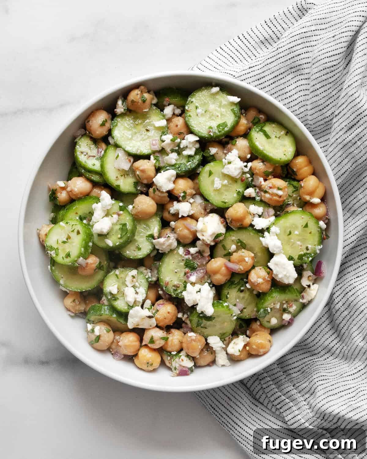 Mediterranean Chickpea Cucumber Refresh 6 A small bowl filled with the fresh chickpea cucumber salad, ready for individual serving.