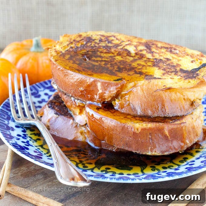 Golden-brown Pumpkin French Toast slices stacked on a plate, ready to be served