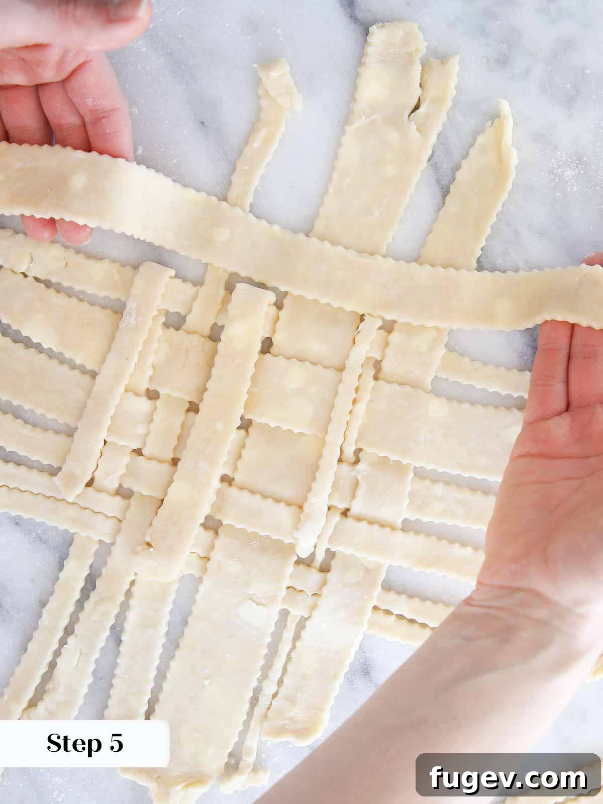 The Art of the Perfect Pie Lattice 8 An overhead view of a pastry chef laying a fresh strip of pie dough onto a developing lattice, demonstrating the over-under technique.