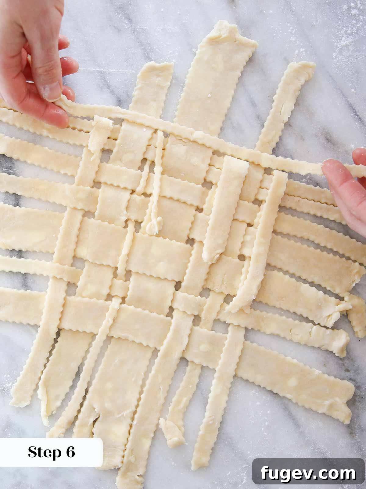 The Art of the Perfect Pie Lattice 9 A completed section of woven lattice pie crust resting on a marble surface, showcasing the intricate pattern before placement on a pie.