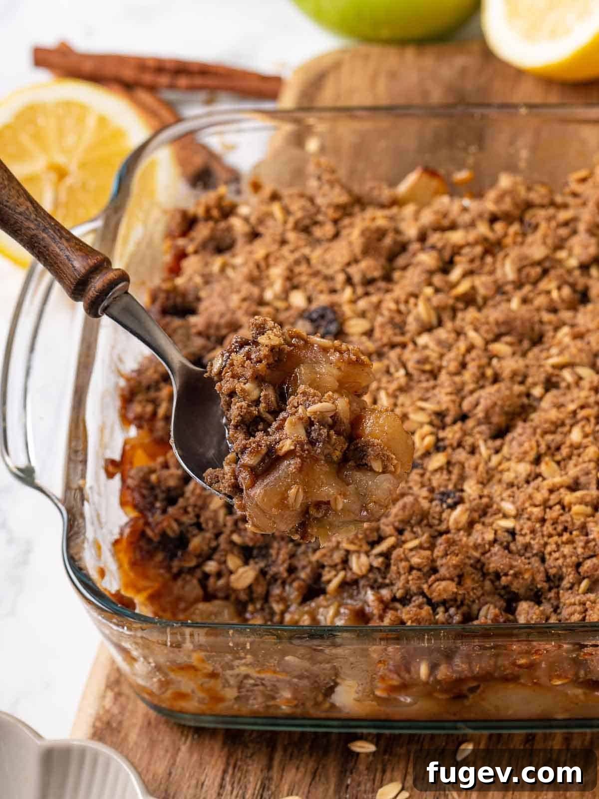 Effortless Apple Crisp Perfection 10 A serving of easy apple crisp being scooped from the baking dish, showing the layers of tender apples and crispy topping, ready for a bowl.