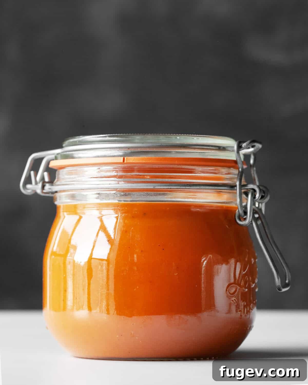 Bursting Roasted Cherry Tomato Sauce 7 A jar of rich, homemade roasted tomato sauce beautifully presented, ready for use.