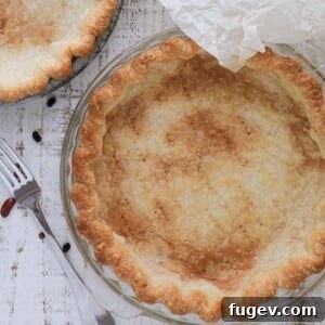 Pre-Bake Perfection: A Guide to Crisp Pie Crusts 14 A perfectly blind-baked pie crust, golden brown and ready for any filling, set against a pristine white background.