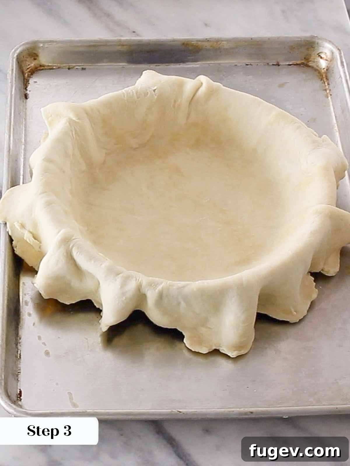 Pre-Bake Perfection: A Guide to Crisp Pie Crusts 5 Overlapping edges of pie dough positioned in a pie plate, awaiting precise trimming.