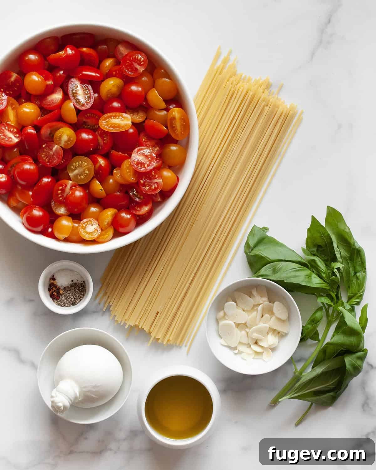 Creamy Burrata & Charred Tomato Pasta 3 A vibrant selection of ingredients for the roasted tomato burrata pasta, including fresh cherry tomatoes, spaghetti, a ball of burrata, fragrant basil, olive oil, and various seasonings.