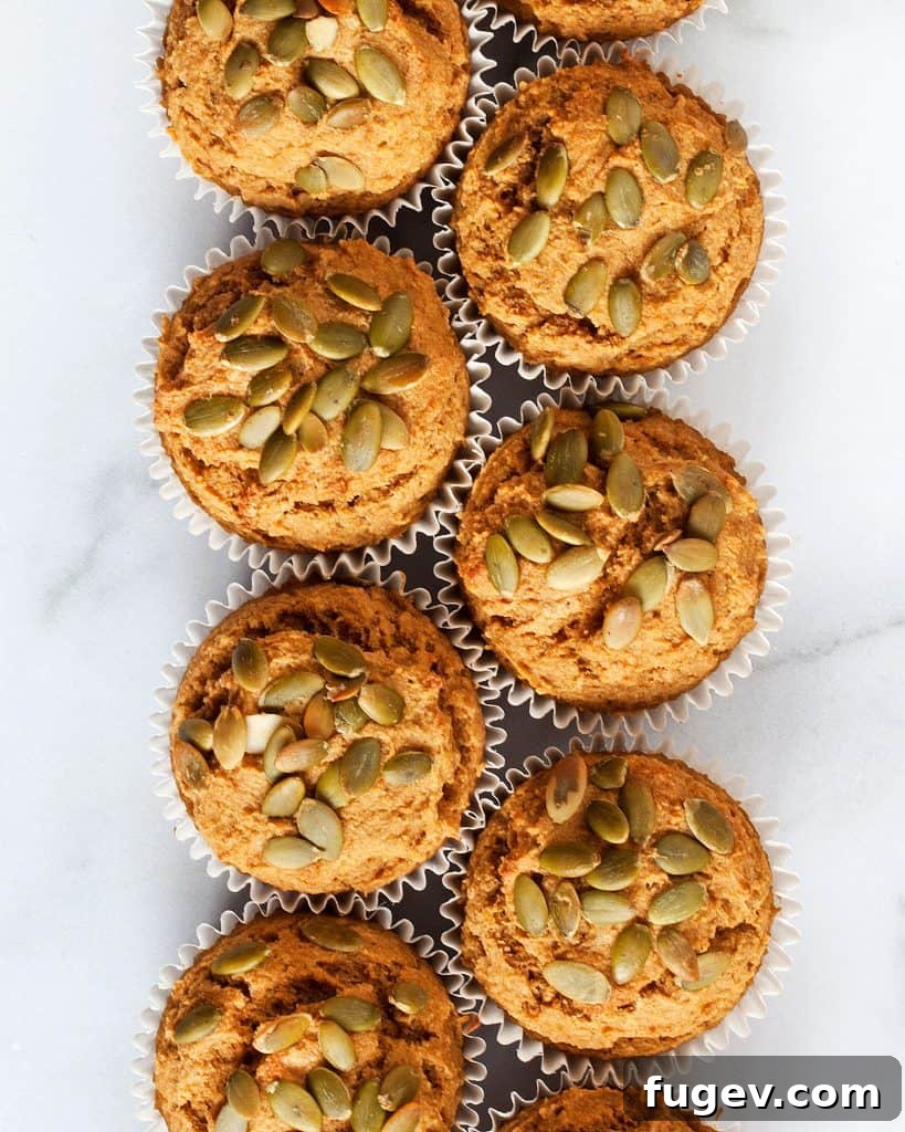 Golden Pumpkin Muffins 4 A stack of perfectly baked spiced pumpkin muffins, ready to be enjoyed