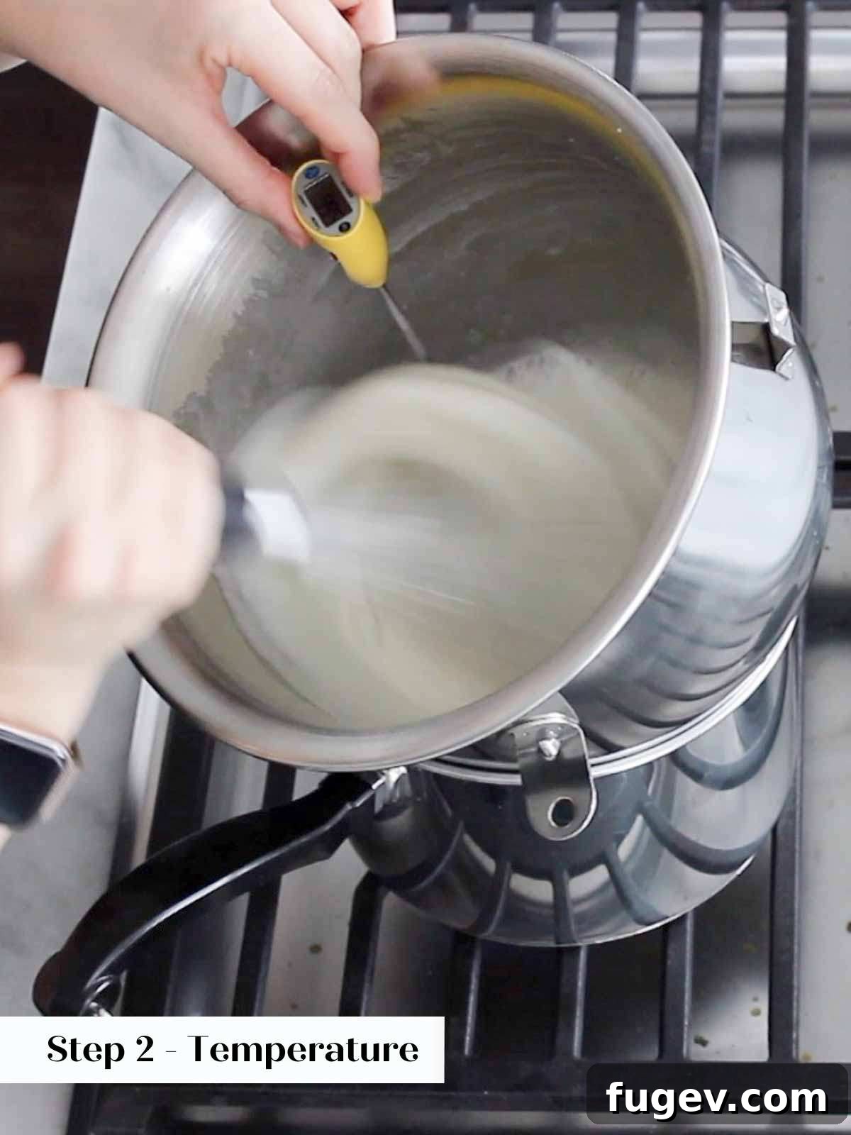 Pillowy Marshmallow Perfection 5 An instant-read thermometer precisely checking the temperature of whipping Swiss meringue in a bowl over heat.