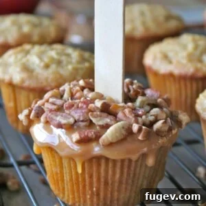 Caramel Apple Cupcakes by The Baker Mama. Spiced apple cupcakes covered with gooey caramel and crunchy nuts for a fun and tasty fall treat.