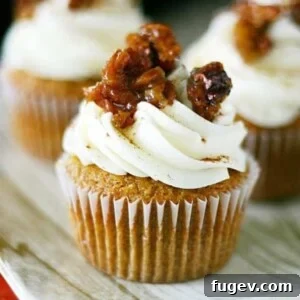 Pecan Pie Pumpkin Cupcakes by Yummy Crumble. Favorite pumpkin cupcake recipe filled with an easy pecan pie filling.