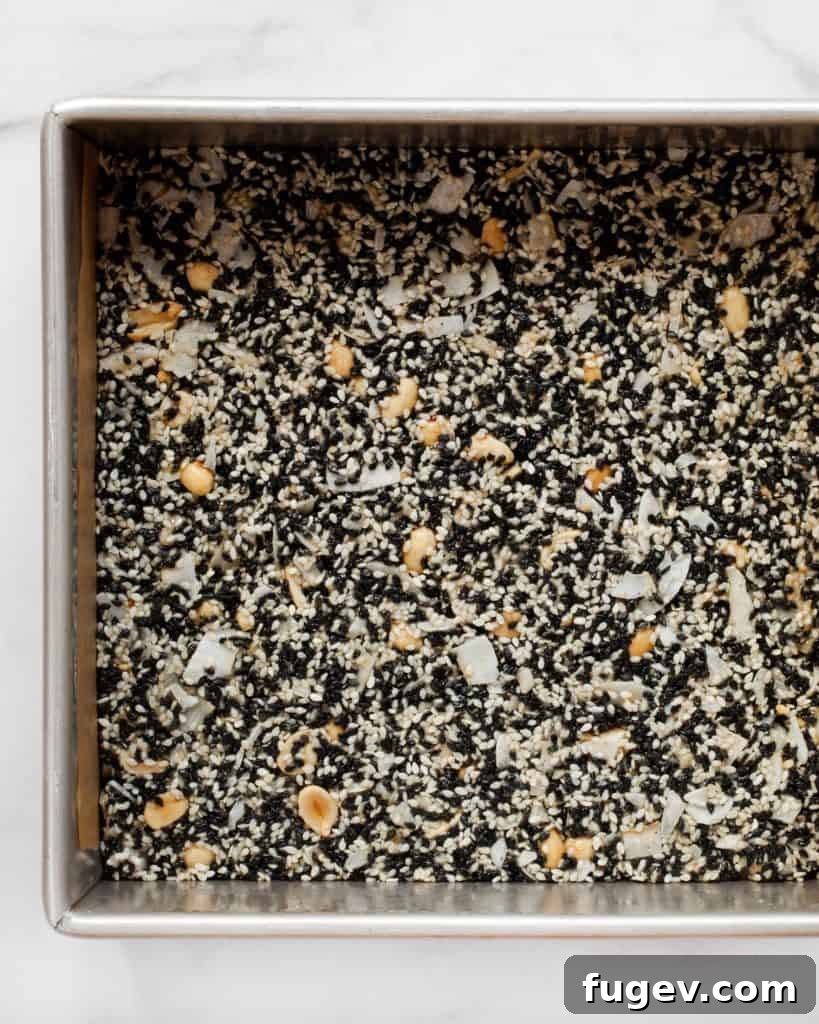 Golden Sesame Peanut Bars 5 Sesame Peanut Bars baking in a square pan, showing a golden brown edge