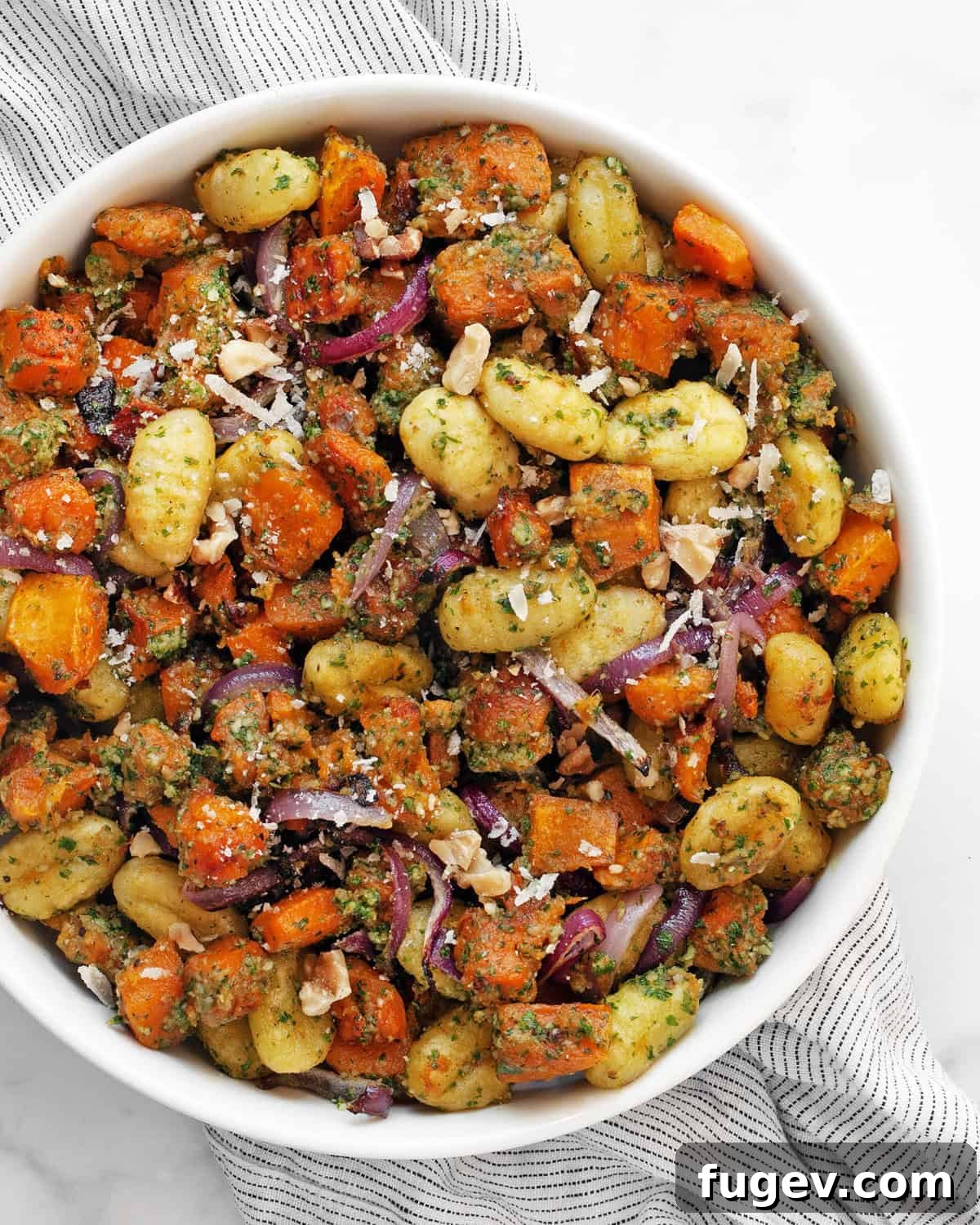 One Pan Butternut Gnocchi with Bright Parsley Pesto 2 A serving of roasted butternut squash sheet pan gnocchi with parsley pesto in a bowl, ready to be enjoyed.