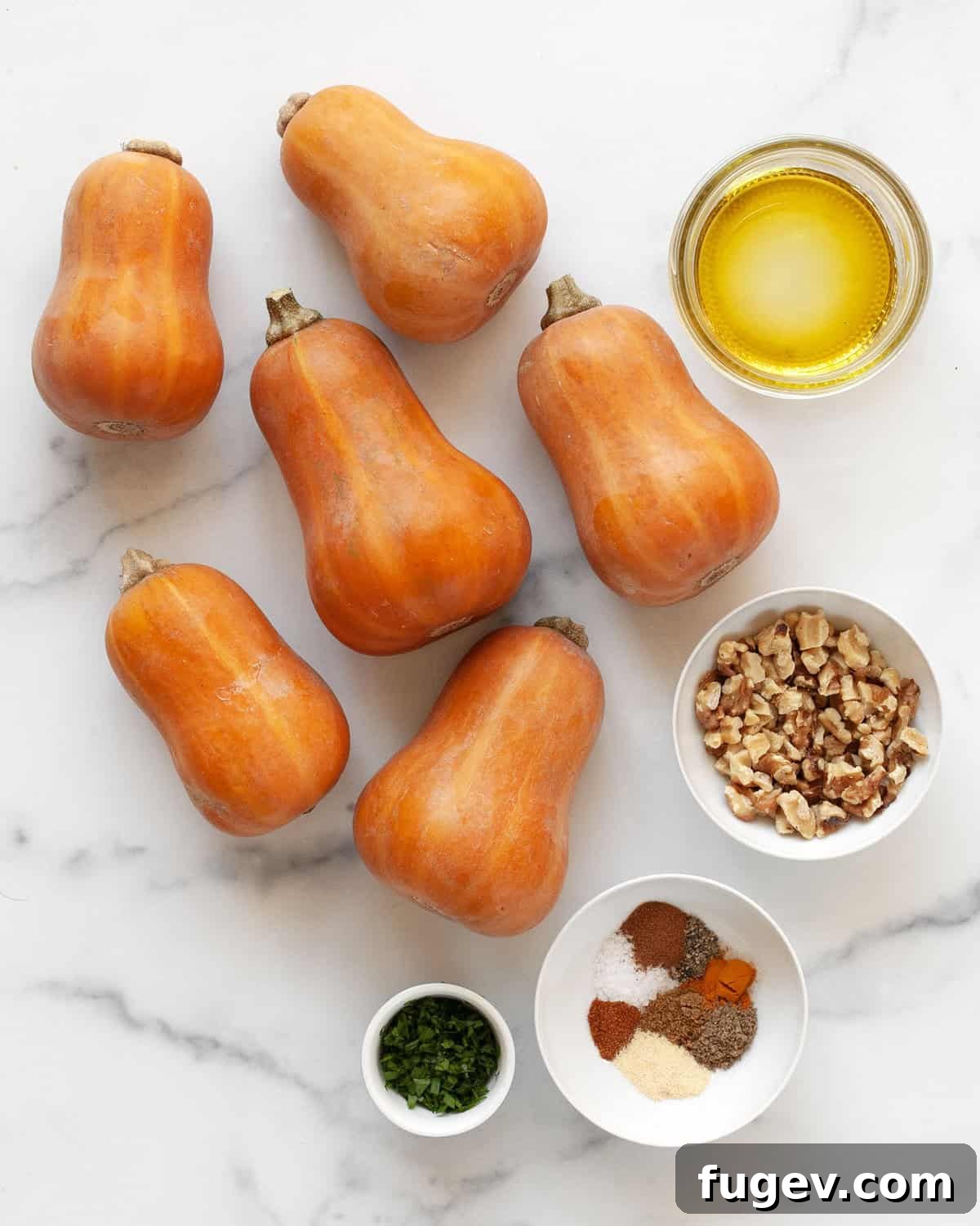 Moroccan Golden Honeynut Roast 3 A flat lay of fresh honeynut squash, olive oil, a selection of vibrant spices, walnuts, and fresh parsley, all ready for the recipe.