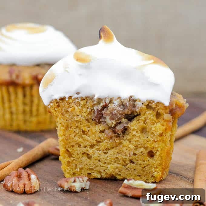 Mini Sweet Potato Casseroles 4 A row of un-frosted Sweet Potato Casserole Cupcakes cooling on a rack, with visible pecan crumble tops.