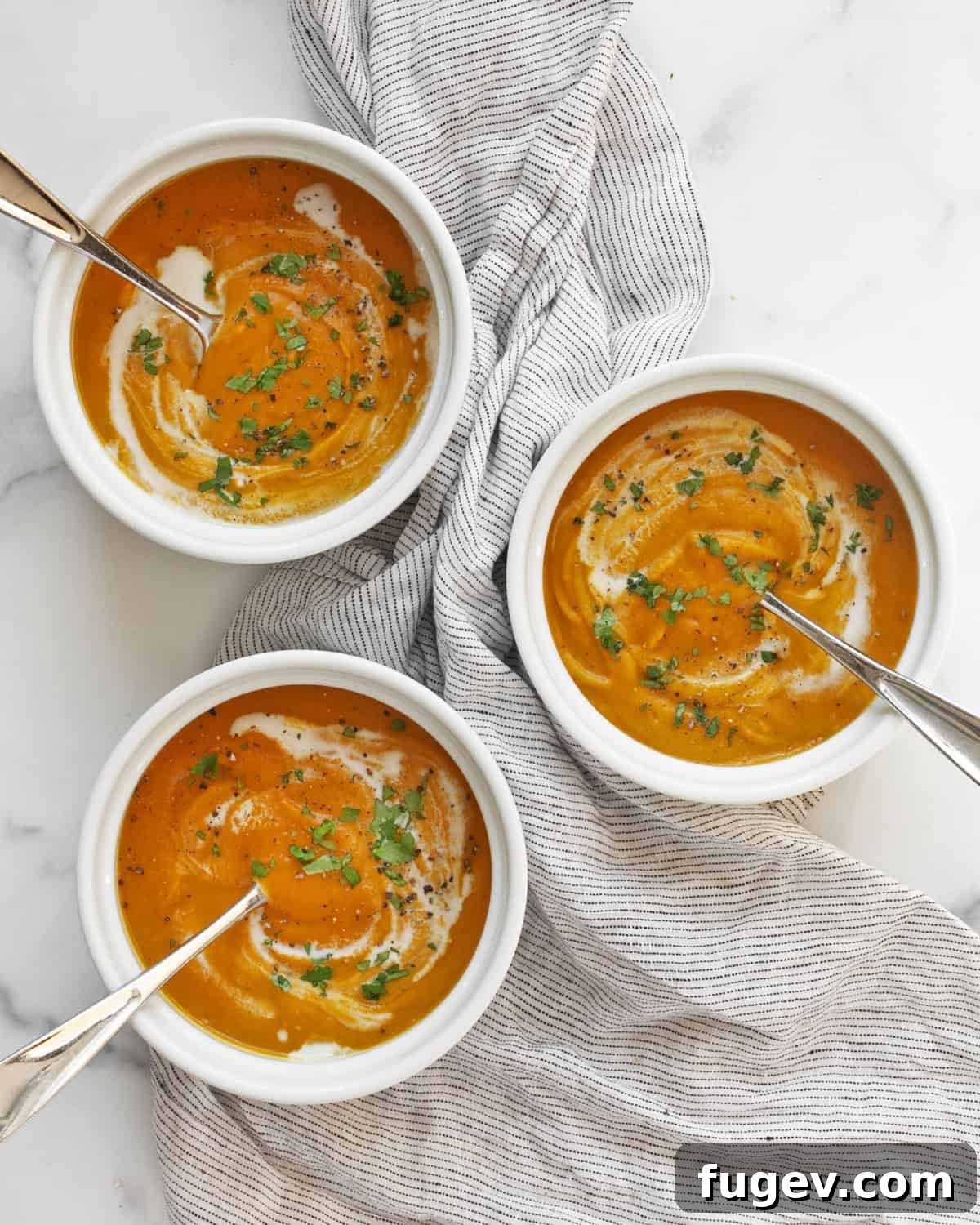 Velvet Roasted Kabocha Soup 8 Three perfectly portioned bowls of creamy roasted kabocha squash soup, ready to be enjoyed.