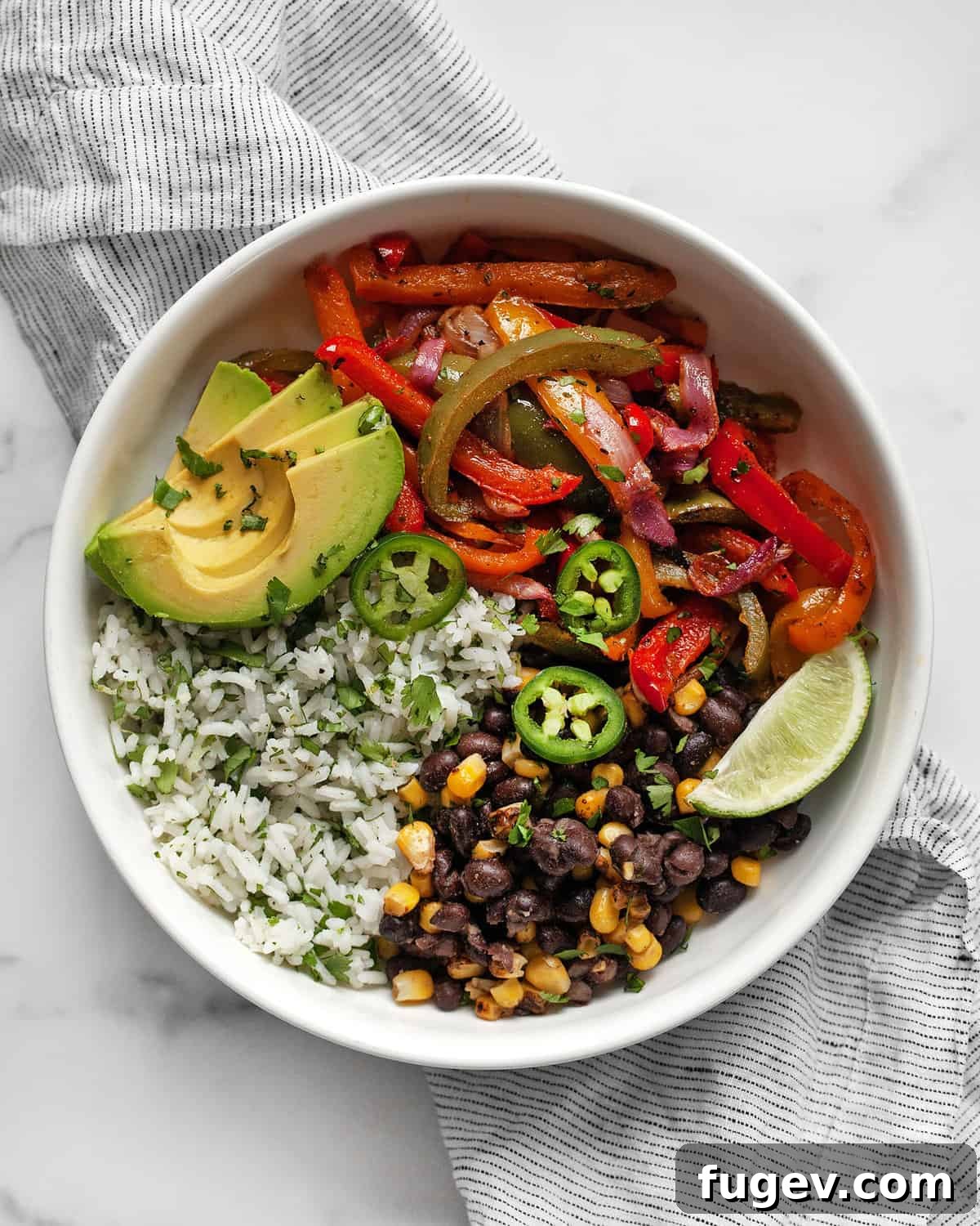 One-Pan Vibrant Veggie Fajita Bowls 2 Veggie fajita bowl with roasted peppers and onions and cilantro lime rice.