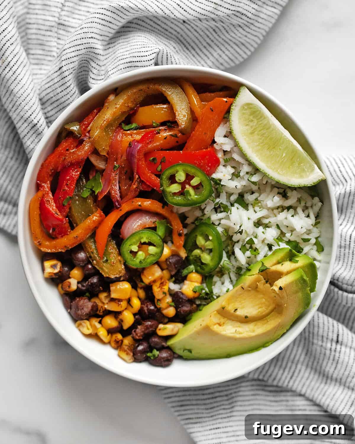 One-Pan Vibrant Veggie Fajita Bowls 7 Veggie fajita bowl with roasted peppers and onions and cilantro lime rice.