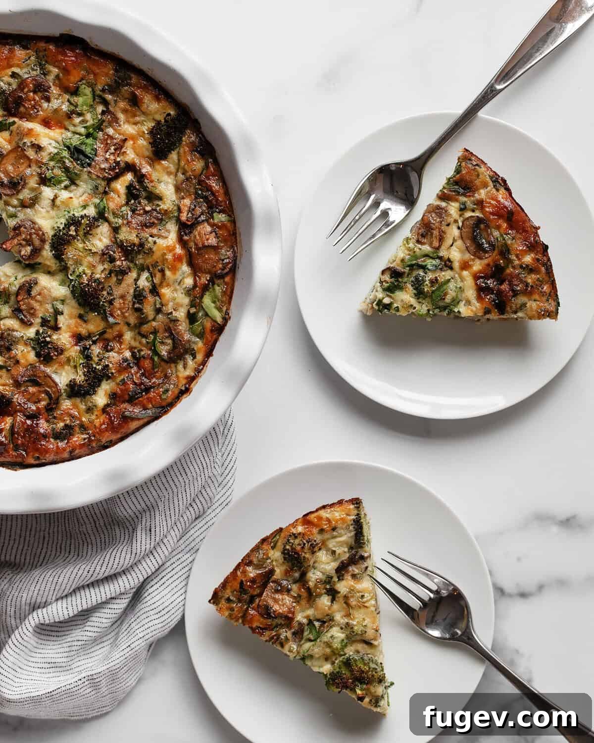 Wholesome Roasted Vegetable & Cottage Cheese Egg Casserole 7 Two perfectly cut slices of cottage cheese egg bake, each placed on an individual plate with a fork, ready to be enjoyed.