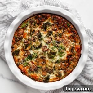 Wholesome Roasted Vegetable & Cottage Cheese Egg Casserole 8 A close-up image of the golden-brown cottage cheese egg bake in a pie dish, showing the roasted vegetables peeking through.