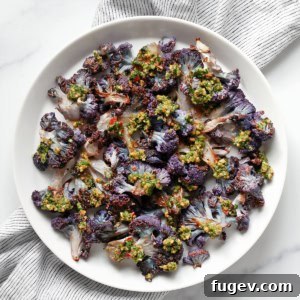 Roasted Amethyst Florets with Zesty Cilantro Burst 8 Roasted purple cauliflower on a plate drizzled with cilantro pesto.