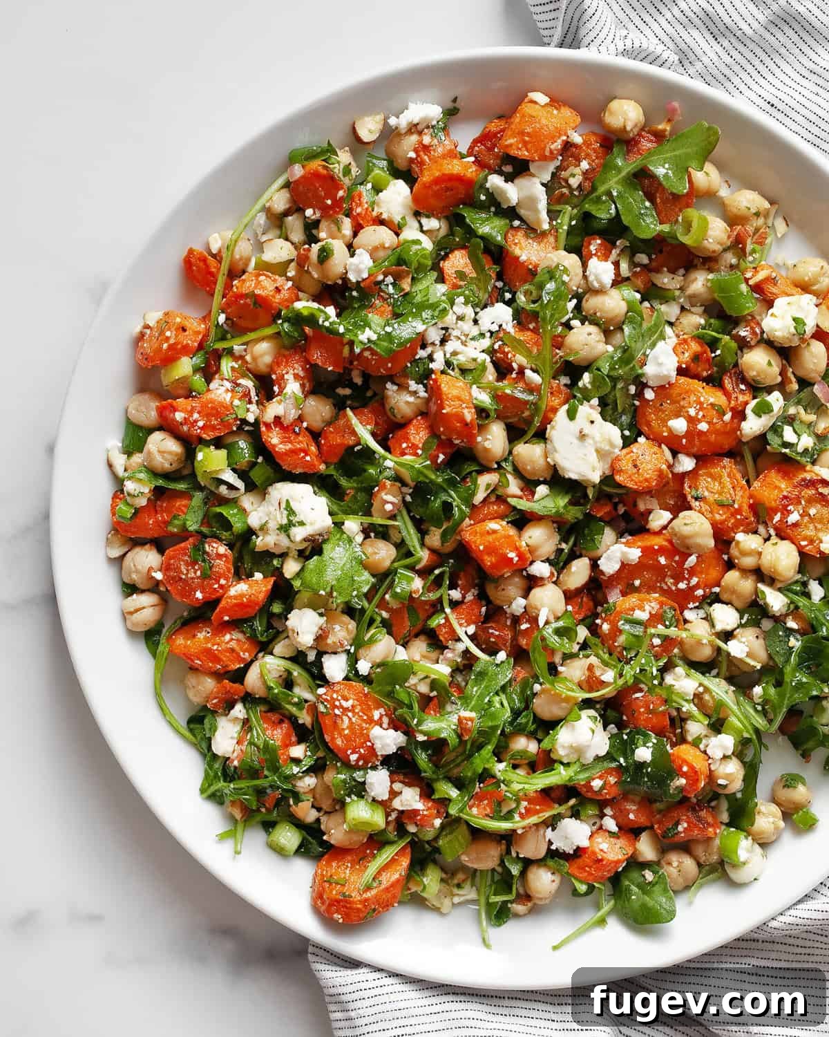 Golden Roasted Carrot Salad 2 Roasted carrot salad with chickpeas on a plate.