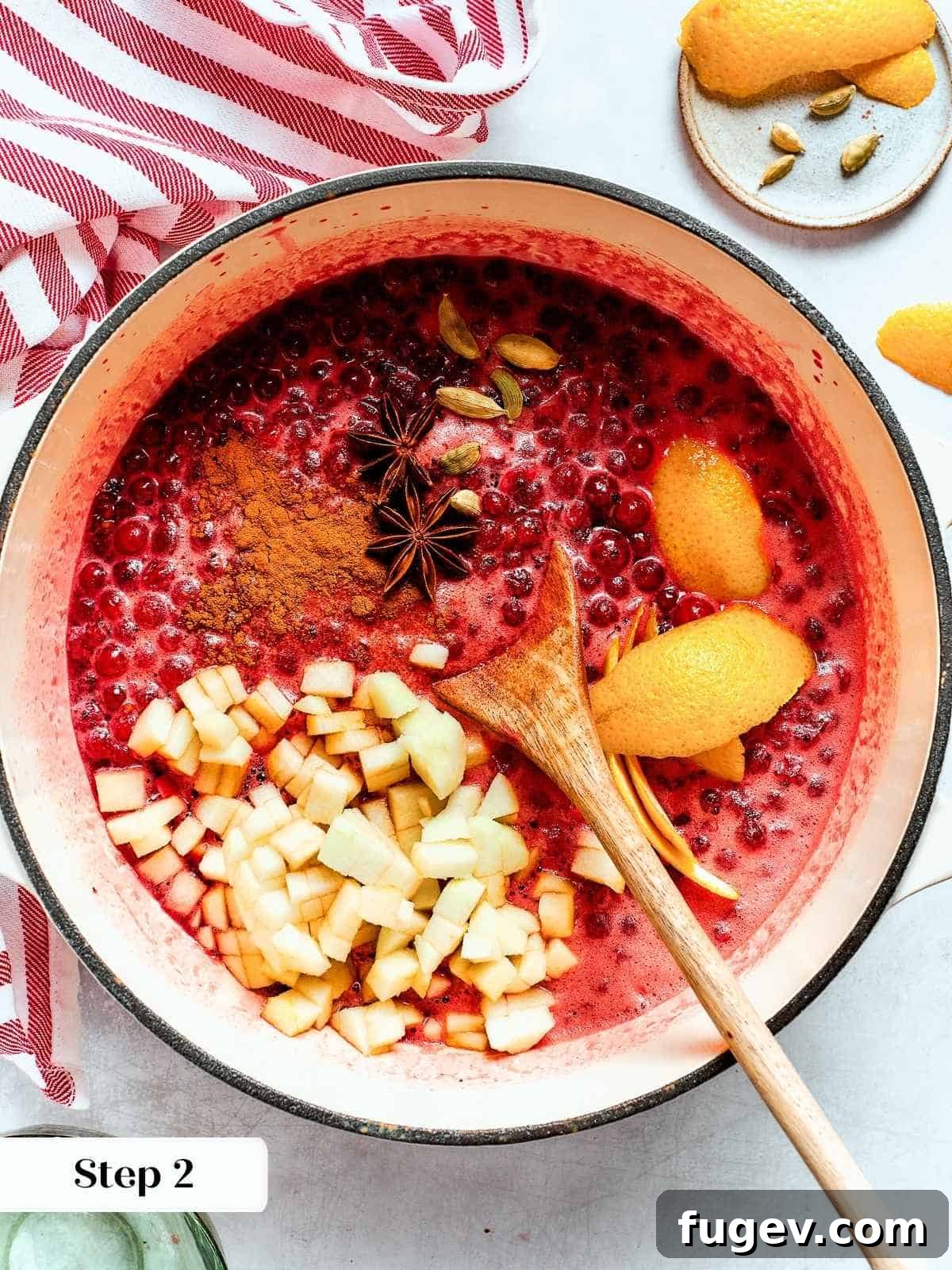 Holiday Cranberry Jewel 8 Saucepan of bubbling cranberries with whole warm spices infusing flavor during the extended cooking process, creating a rich aroma.