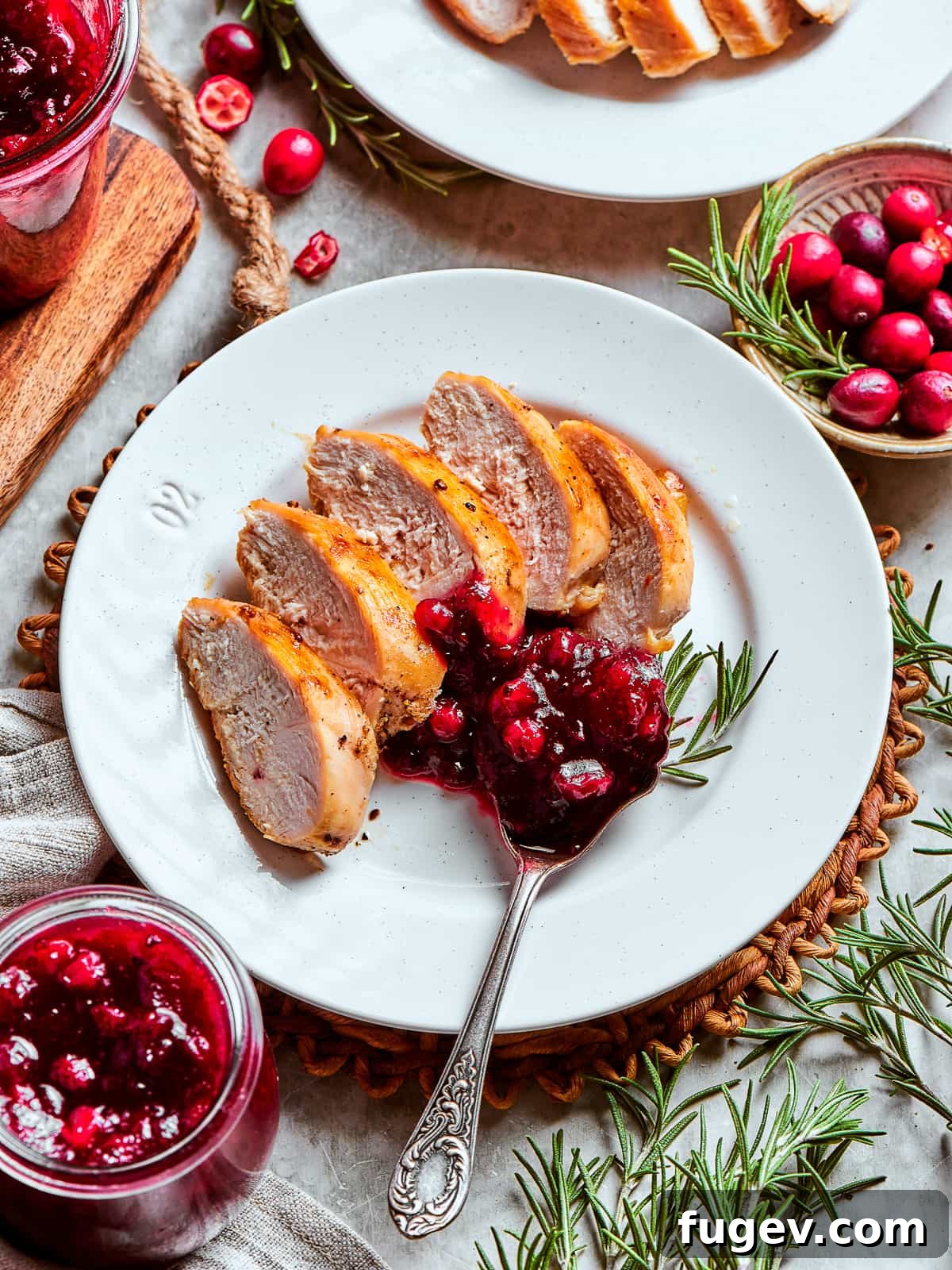Holiday Cranberry Jewel 9 A generous portion of homemade cranberry sauce served on a white plate next to succulent slices of roasted turkey, embodying a classic Thanksgiving dinner scene.