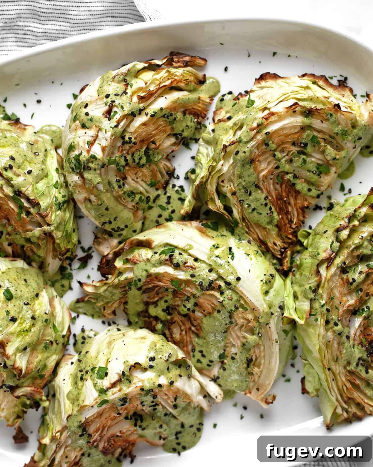 Perfectly Roasted Cabbage Steaks 7 Beautifully roasted cabbage wedges on an elegant oval platter, ready to be served or stored as leftovers.