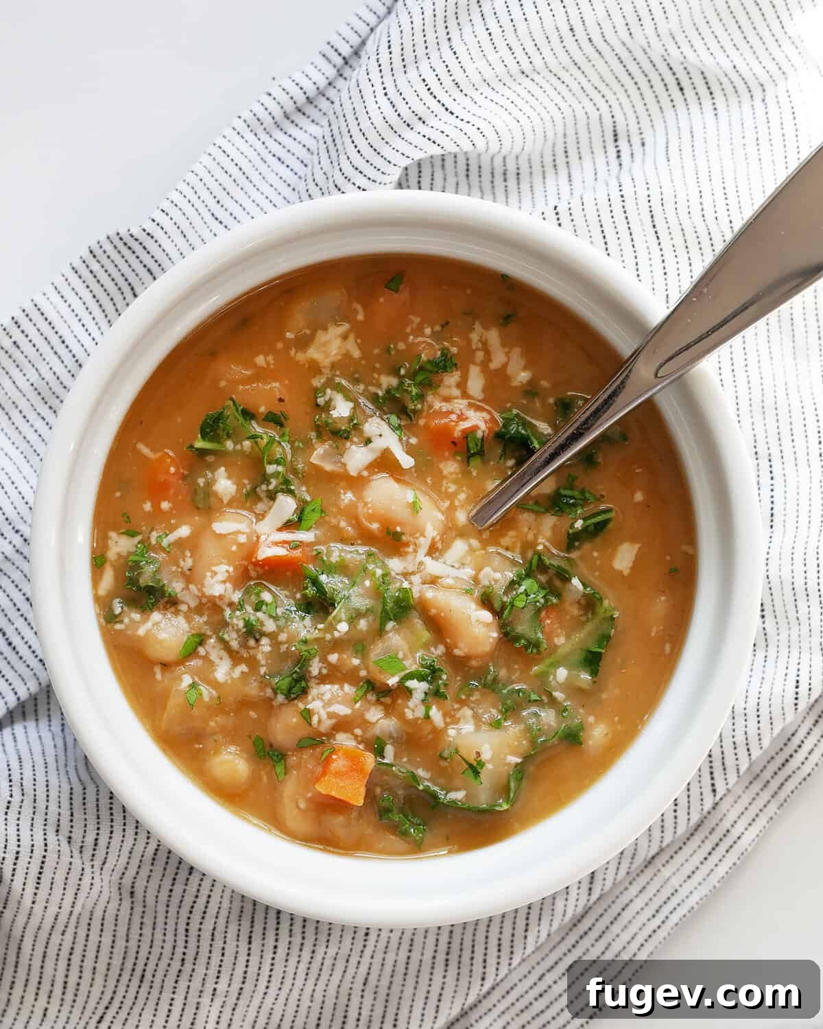 Velvety Tuscan White Bean Soup 2 Bowl of creamy Italian white bean soup, garnished with fresh herbs and a drizzle of olive oil.