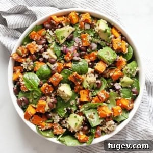 Spiced Roasted Sweet Potato & Black Bean Bowl 8 Sweet potato salad with black beans, quinoa and avocados in a bowl.