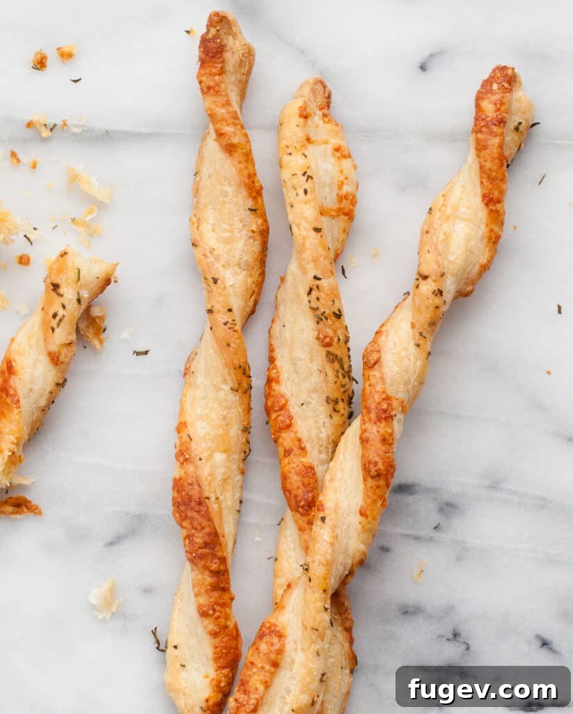 Gourmet Gouda & Rosemary Twists 2 Crispy Rosemary Gouda Straws ready to be served as an appetizer