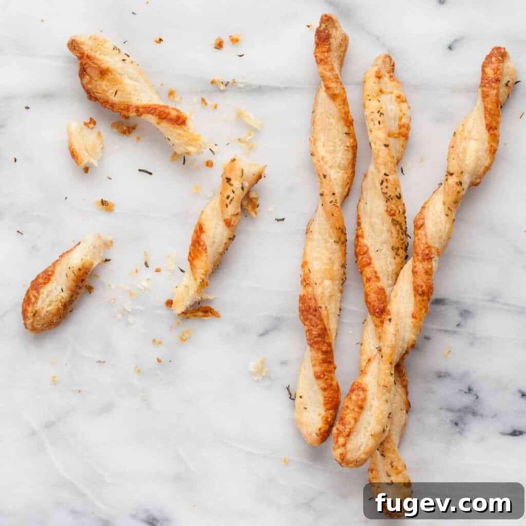 Gourmet Gouda & Rosemary Twists 3 Close-up of a hand reaching for a Rosemary Gouda Straw