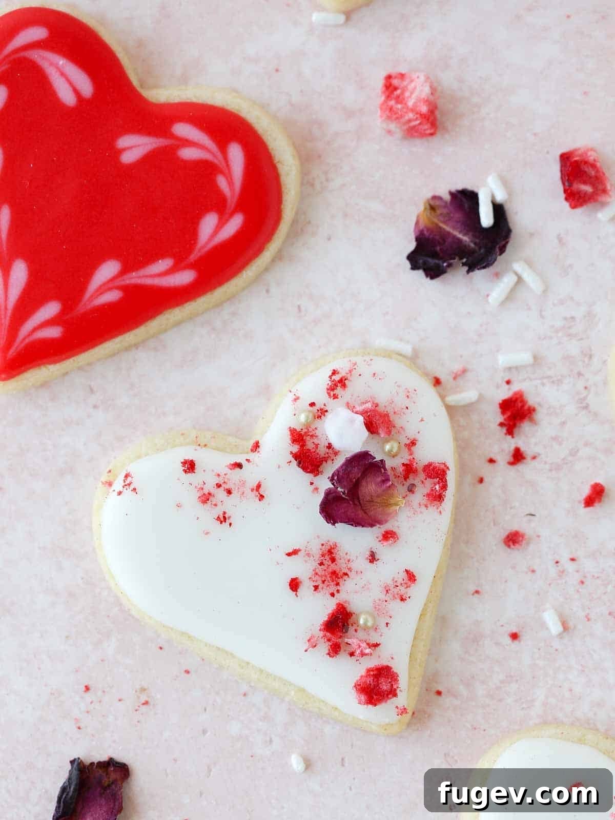 Cupid's Confections 2 Beautifully decorated heart sugar cookies arranged on a pink background, perfect for Valentine's Day.