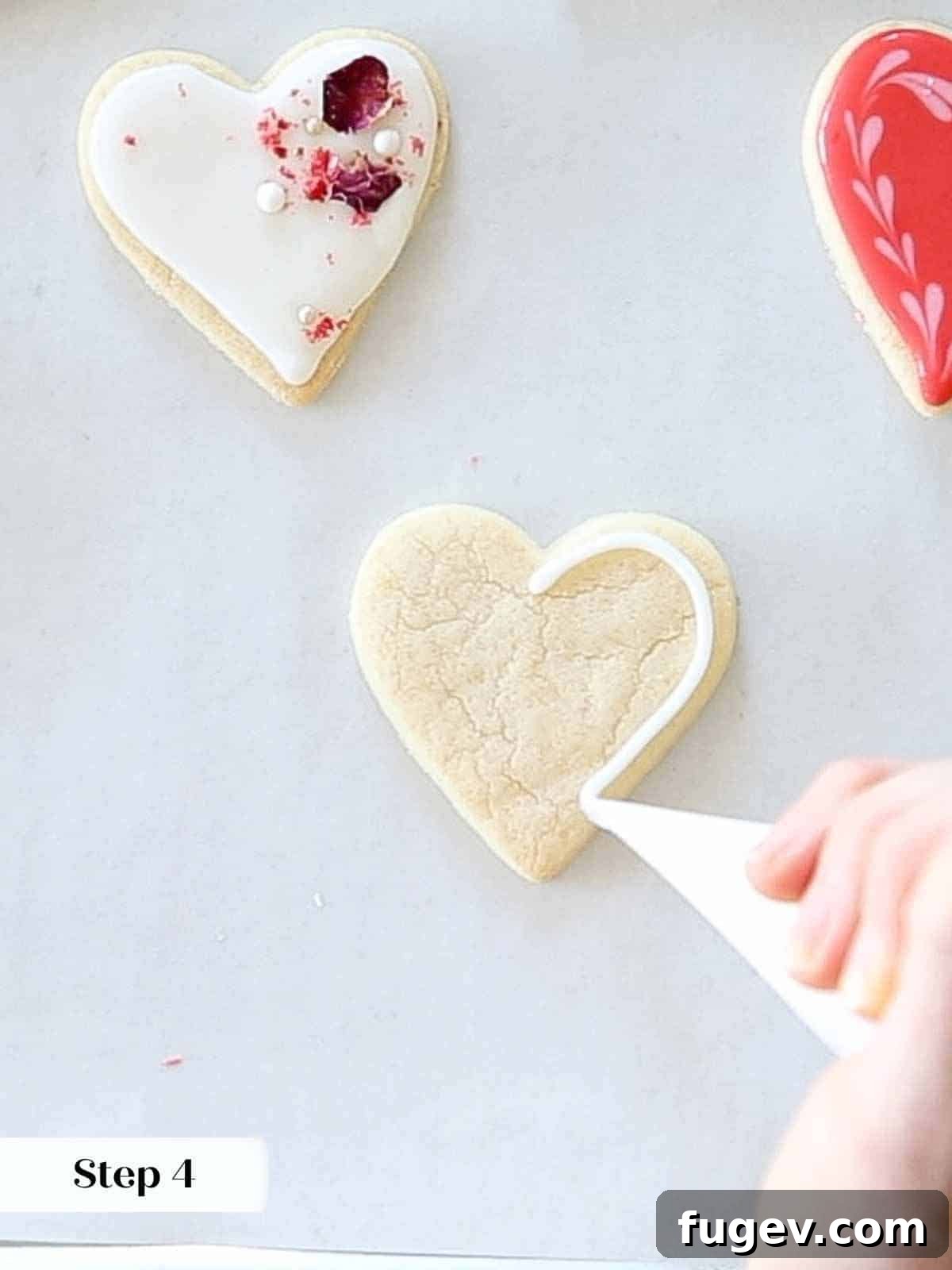 Cupid's Confections 17 Outlining a sugar cookie with crisp white royal icing for a classic look.