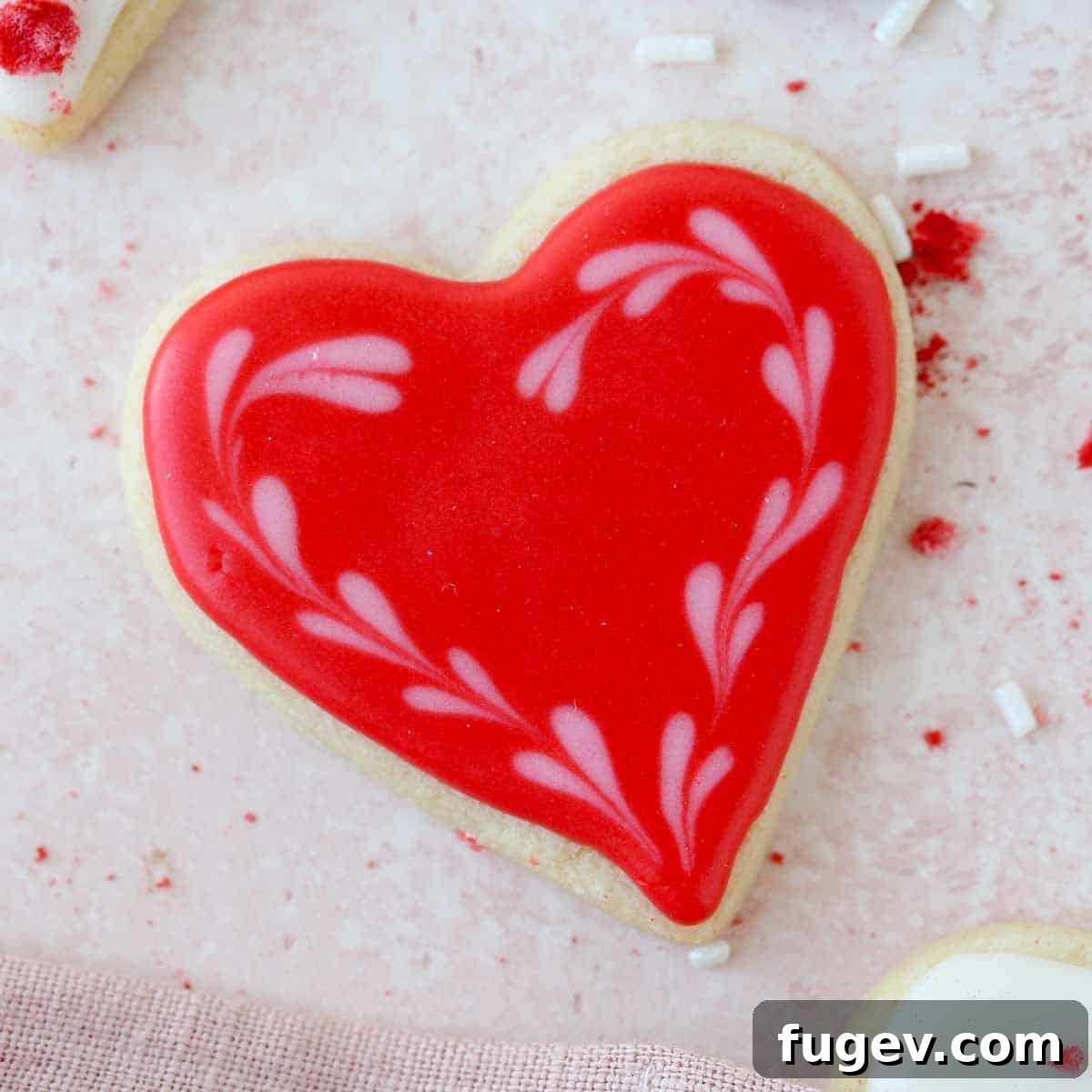 Cupid's Confections 5 A single red heart-decorated sugar cookie, showcasing intricate icing work.