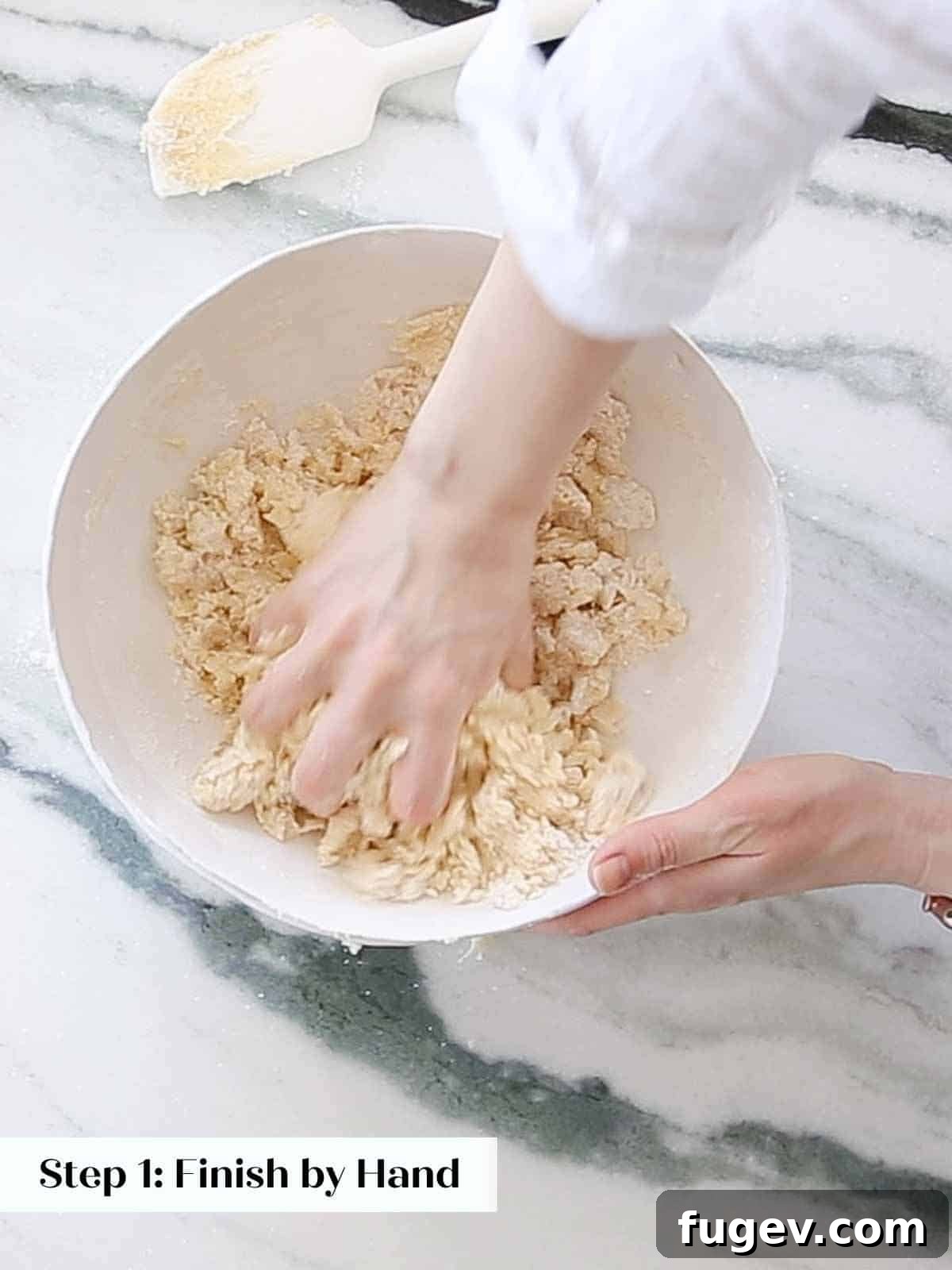 Cupid's Confections 7 Mixing sugar cookie dough by hand in a bowl, showcasing the simplicity of the process.