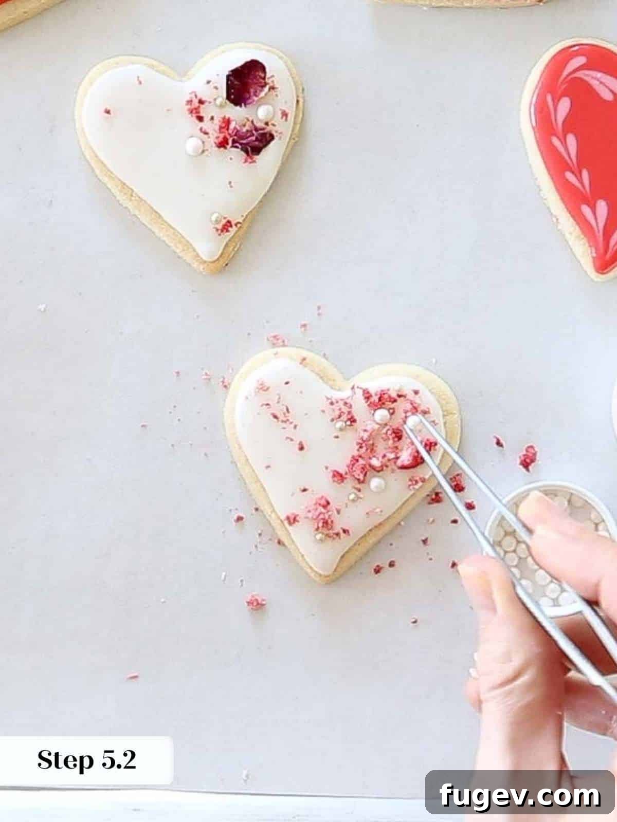 Decadent Chocolate Sugar Delights 12 adding sugar pearls to sugar cookie hearts.
